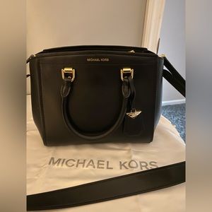 Michael Kors black small handbag with shoulder strap.